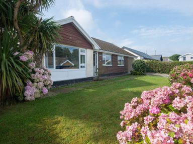 A single story house with a front garden and pink flowers at Greenaway 4 Rockhaven Gardens Rock