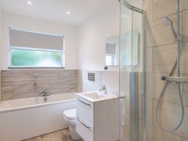 A bathroom with a bathtub a toilet a sink and a shower at Greenaway 4 Rockhaven Gardens Rock