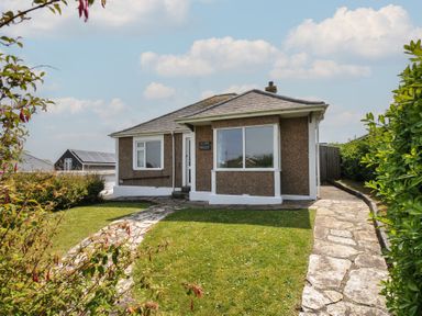 A house with a garden and pathway at Hillcroft Bungalow Daymer Bay