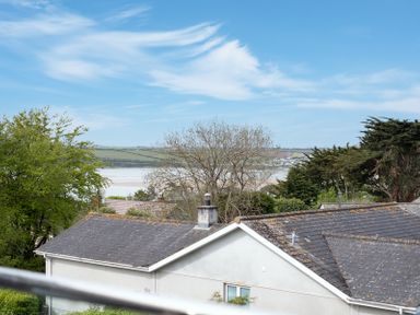 Rooftops of houses with trees and a body of water in the background at Flaad House in Rock