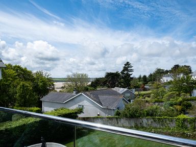 A view of houses trees and a river under a cloudy sky at Flaad House in Rock
