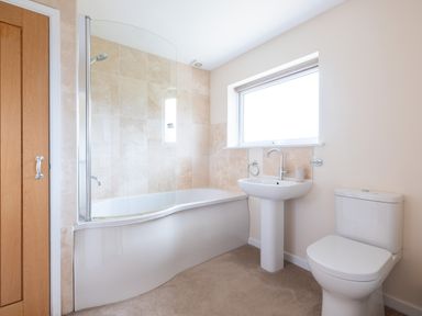 A bathroom with a bathtub shower sink toilet and a window at Flaad House Rock