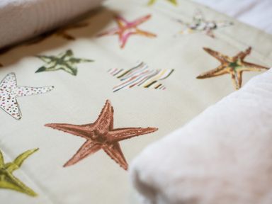 A fabric with printed starfish patterns and a folded towel at Brookside in Polzeath