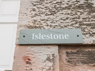 A wall-mounted stone plaque with the word Islestone at Islestone 1 Temperance Terrace Berwick-Upon-Tweed