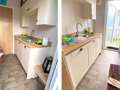 A kitchen area with white cabinets wooden countertops a stainless steel sink cleaning tools and toys on the counter a door leading outside a basket and a small bench at Meadow Lodge in Cayton