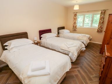 A bedroom with three single beds each with white bedding and towels on top at 1 The Warren Robeston Wathen near Narberth