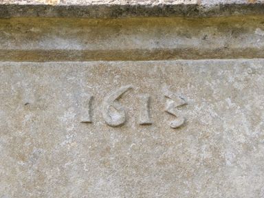 A carved stone with the year 1613 engraved on it