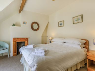A bedroom with a double bed and bedside tables with lamps at Sea Spray in Watchet