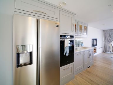 A kitchen area with a stainless steel refrigerator oven sink and dining area at Megizzy in Polzeath