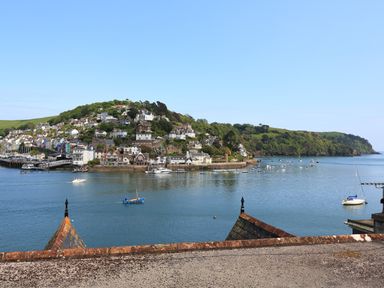 A coastal town with houses on a hill overlooking a body of water with boats at Ferry View in Dartmouth