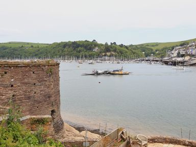 A harbor with a ferry crossing the water with boats and houses on the shore at Ferry View in Dartmouth
