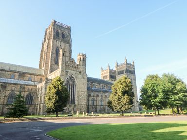 Large stone cathedral with towers and trees in a grassy area at Otters Holt in Winston near Staindrop