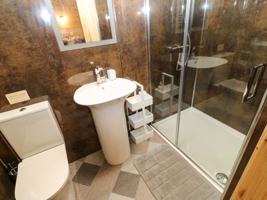 A bathroom with a toilet sink shower and a bath mat at Otters Holt Winston near Staindrop