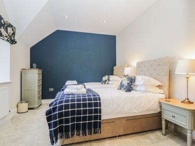 A bedroom with twin beds bedside tables lamps and a chest of drawers at Tarn End Cottages 5 Talkin near Brampton Cumbria