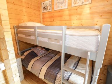 A bedroom with a bunk bed and wooden walls at Port Heron Lodge Ballykeeran near Glasson County Westmeath