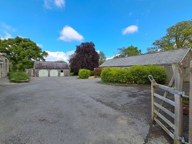 An outdoor area with a garage and shed at Carreg Cennen Cottage Llandeilo