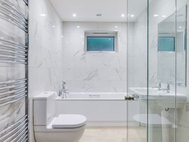 A bathroom with a toilet bathtub sink and towel rack at The Garden House in Rock