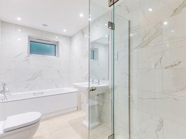 A bathroom with a bathtub toilet pedestal sink and glass shower at The Garden House in Rock