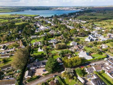 An aerial view of a village with houses trees and a river in the background at The Garden House in Rock
