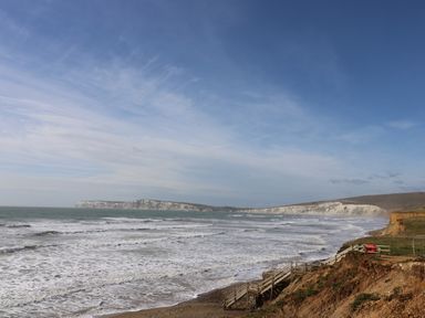 A coastline with waves and white cliffs under a blue sky at Chianti in Seaview