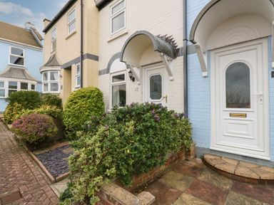 Exterior view of terraced houses with white doors and covered entrance at Little Tern Brewers Quay Harbour