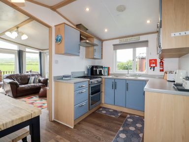 A kitchen with cabinets and appliances at Orchard View in Bossiney near Tintagel
