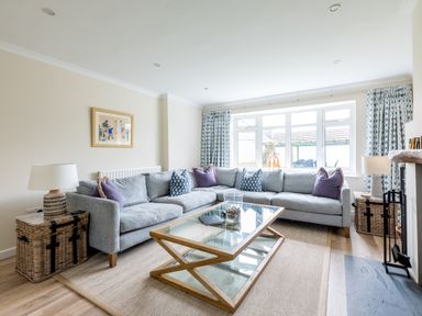 A living room with a gray sectional sofa and a glass coffee table at Silverdale in Rock