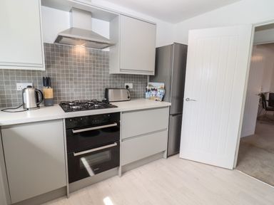A kitchen with a gas stove oven fridge kettle and toaster at 3 Granbrook Lane in Mickleton Gloucestershire