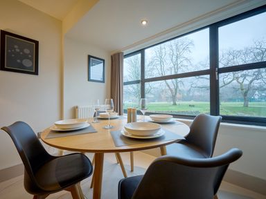 A dining area with a round table and chairs at Riverside Park 1 in Keswick