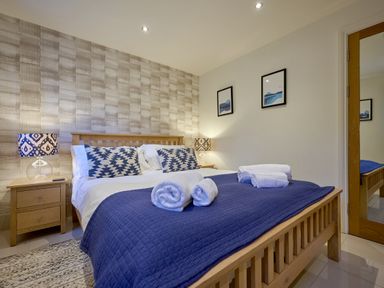 A bedroom with a bed and bedside table at Riverside Park 1 in Keswick