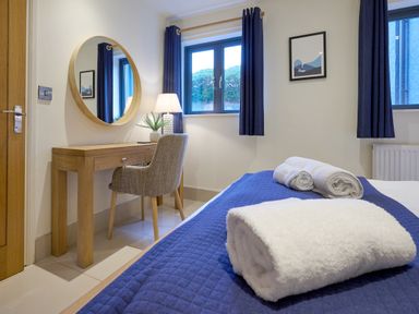 A bedroom with a bed and desk at Riverside Park 1 in Keswick