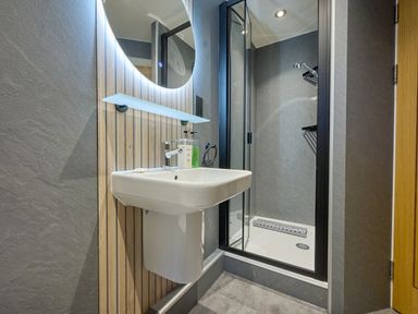 A bathroom with a sink and shower at Riverside Park 1 in Keswick