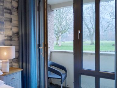 A bedroom with a window overlooking a park at Riverside Park 1 in Keswick