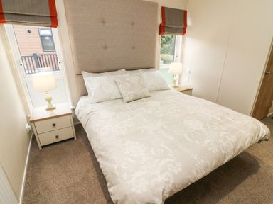 A bedroom with a bed bedside tables and lamps at The Warren in Hellifield