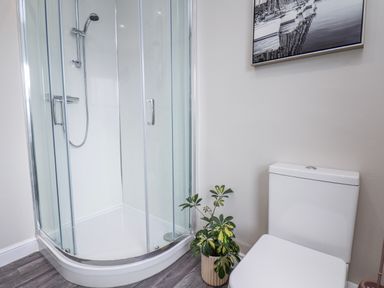 A bathroom with a shower and a toilet at 24 Baxtergate in Whitby