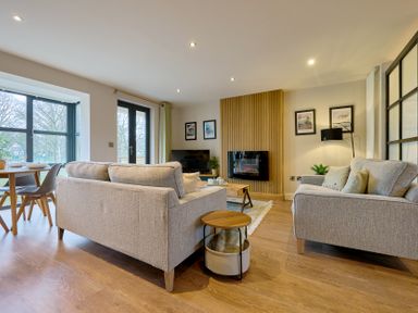 A living room with a sofa and table at Riverside Park 3 in Keswick