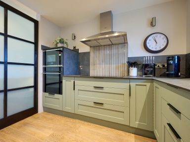 A kitchen with cabinets, appliances and utensils at Riverside Park 3 Keswick