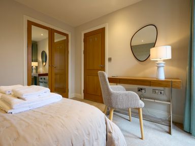 A bedroom with a bed and desk at Riverside Park 3 in Keswick