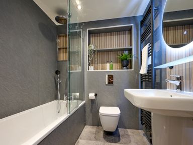 A bathroom with a bathtub, sink, and toilet at Riverside Park 3 in Keswick