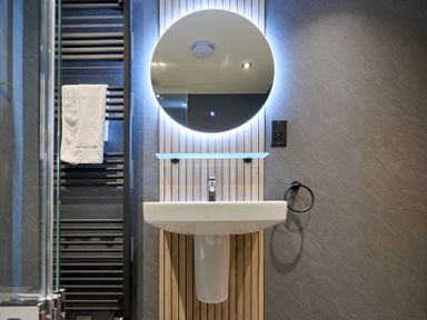 A bathroom with a washbasin and a mirror at Riverside Park 3 in Keswick