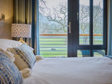 A bedroom with a bed and a view of the outdoors at Riverside Park 3 in Keswick