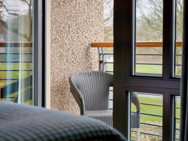A balcony view with a chair at Riverside Park 3 in Keswick