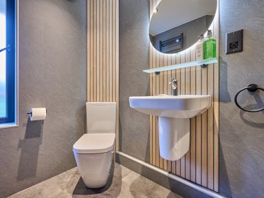 A bathroom with a toilet and sink at Riverside Park 3 in Keswick