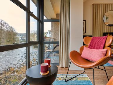 A living room with a view of the river at Riverside Park 5 in Keswick
