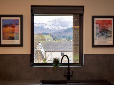 A kitchen with a view of a mountain and houses at Riverside Park 5 Keswick
