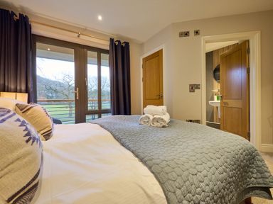 A bedroom with a bed and towels at Riverside Park 5 in Keswick