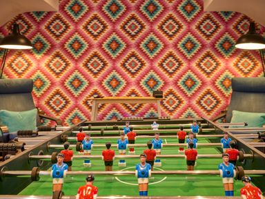 A foosball table with players in a game room at Riverside Park 5 in Keswick