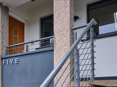 An entrance with a door and railing at Riverside Park 5 in Keswick