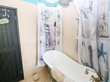 A bathroom with a bathtub and shower in The Woodlands Lower Level Stepaside