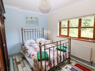 A bedroom with a bed and window at The Woodlands Lower Level Stepaside
